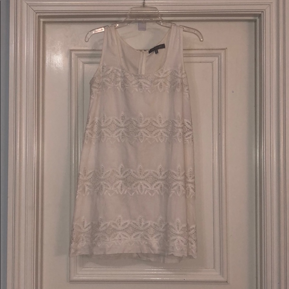 White dress with Details across the front.
